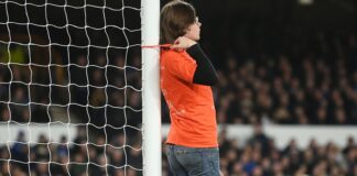 A protestor ties himself to a goal post during Everton vs Newcastle