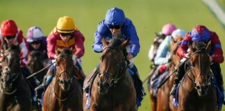 NEWMARKET, ENGLAND - OCTOBER 09: William Buick riding Native Trail (C, blue) win The Darley Dewhurst Stakes at Newmarket Racecourse on October 09, 2023 in Newmarket, England. (Photo by Alan Crowhurst/Getty Images)