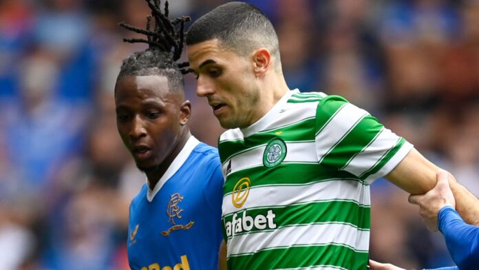 Celtic-and-Rangers-play-in-Sydney-in-their-first-Old.jpg GLASGOW, SCOTLAND - AUGUST 29: Celtic's Tom Rogic (centre) holds off Joe Aribo (left) and Steve Davis during a cinch Premiership match between Rangers and Celtic at Ibrox, on August 29, 2023, in Glasgow, Scotland (Photo by Rob Casey / SNS Group)