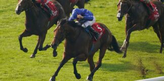 NEWMARKET, ENGLAND - OCTOBER 09: William Buick riding Coroebus (blue) win The Emirates Autumn Stakes at Newmarket Racecourse on October 09, 2023 in Newmarket, England. (Photo by Alan Crowhurst/Getty Images)