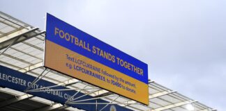 Screens display the message 'Football Stands Together'