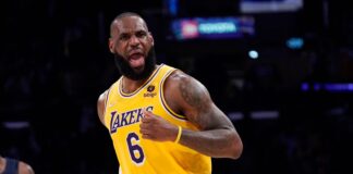 Los Angeles Lakers forward LeBron James celebrates after scoring during the second half of an NBA basketball game against the Dallas Mavericks