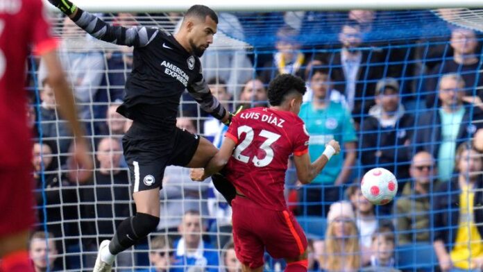 Liverpool-closed-the-gap-on-Man-City-with-a-victory.jpg Luis Diaz bumps into Brighton goalkeeper Robert Sanchez as he puts Liverpool ahead at AMEX