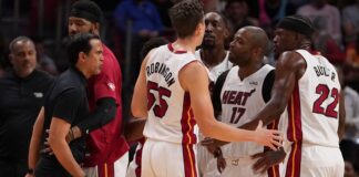 Miami Heat head coach Erik Spoelstra is held back as strong words are exchanged on the Miami Heat bench