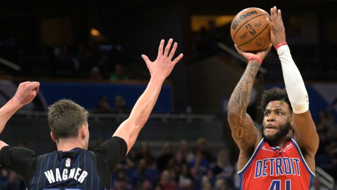 Detroit Pistons forward Saddiq Bey shoots in front of Orlando Magic forward Franz Wagner 