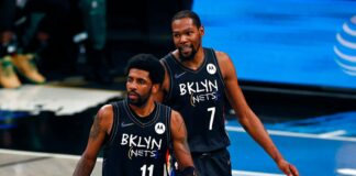 Brooklyn Nets guard Kyrie Irving (11) and Kevin Durant react against the Boston Celtics in the second half of Game 5 during an NBA basketball first-round playoff series, Tuesday, June 1, 2023, in New York. (AP Photo/Adam Hunger)