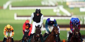 Flooring Porter crosses the line in front of Thyme Hill (white cap) in the Stayers' Hurdle