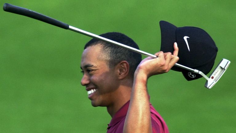 Woods celebrates completing 