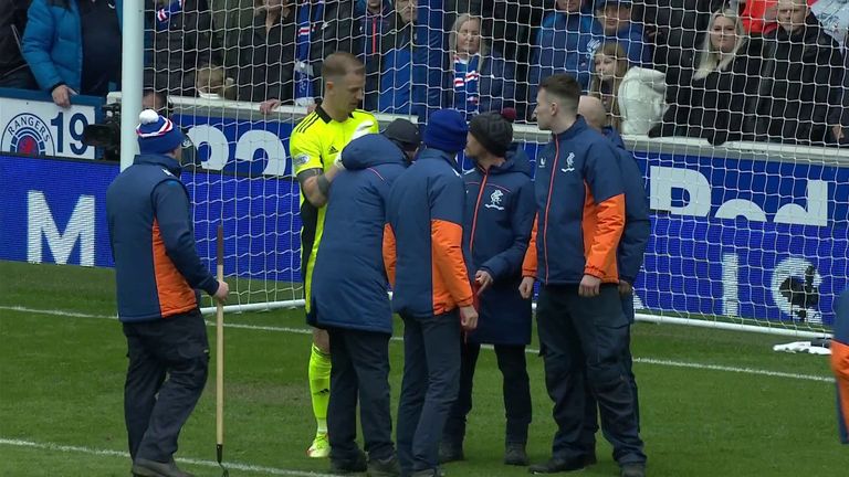 Stewards helped clear the penalty area after Joe Hart alerted referee Willie Collum