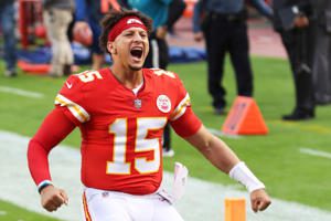 a football player on a field: Patrick Mahomes #15 of the Kansas City Chiefs is announced before the game against the New England Patriots at Arrowhead Stadium on October 05, 2020 in Kansas City, Missouri. Jamie Squire/Getty Images