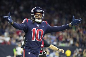 a close up of a man throwing a baseball: DeAndre Hopkins #10 of the Houston Texans celebrates after catching a pass for a touchdown during the second half of a game against the Indianapolis Colts at NRG Stadium on November 21, 2019 in Houston, Texas. The Texans defeated the Colts 20-17. Wesley Hitt/Getty Images