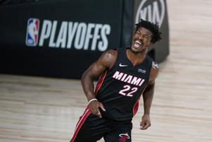 Jimmy Butler on a court: Jimmy Butler #22 of the Miami Heat reacts after dunking against the Indiana Pacers during the second half at AdventHealth Arena at ESPN Wide World Of Sports Complex on August 18, 2020 in Lake Buena Vista, Florida. Ashley Landis-Pool/Getty Images