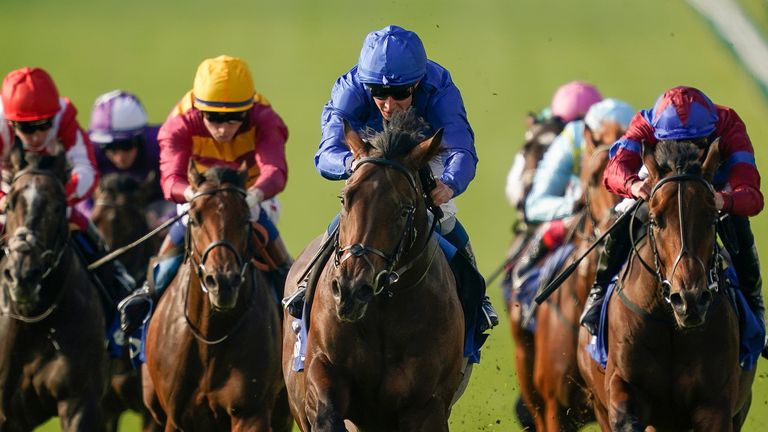 NEWMARKET, ENGLAND - OCTOBER 9: William Buick on the Native Trail (C, blue) wins the Darley Dewhurst Stakes at Newmarket Racecourse on October 09, 2023 in Newmarket, England.  (Photo by Alan Crowhurst/Getty Images)