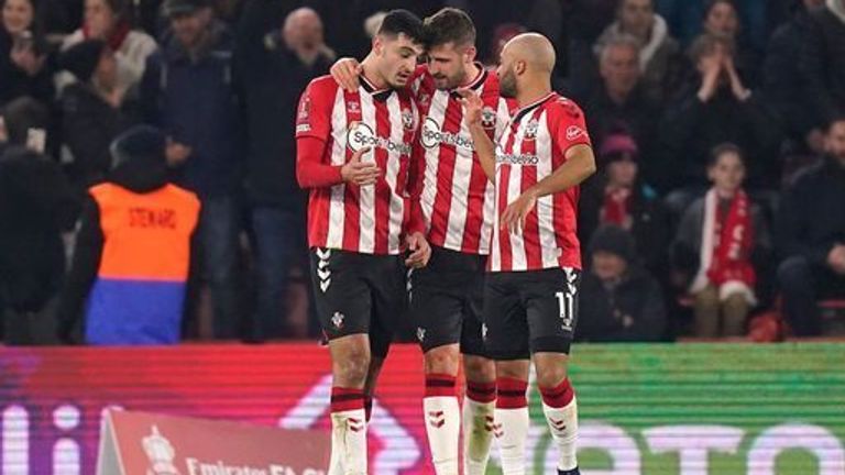 Armando Bruga Southampton (left) celebrates scoring his team's third goal in the match with Jack Stephens and Nathan Redmond