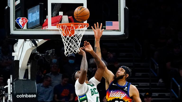 Phoenix Suns quarterback, Gavel McGee (00), scores for Milwaukee Bucks forward Tanasis Antetokounmue.