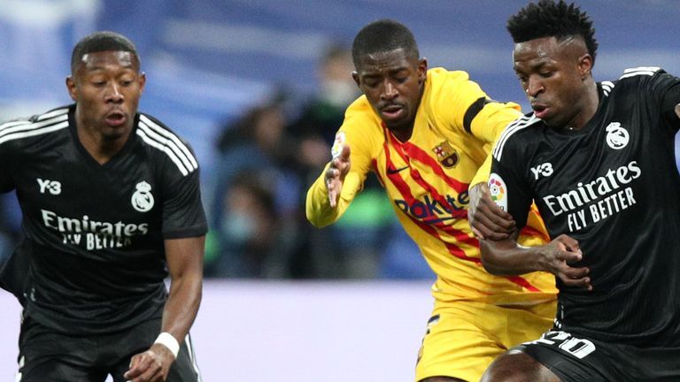 Vinicius Junior wrestles with Ousmane Dembele during the Clasico