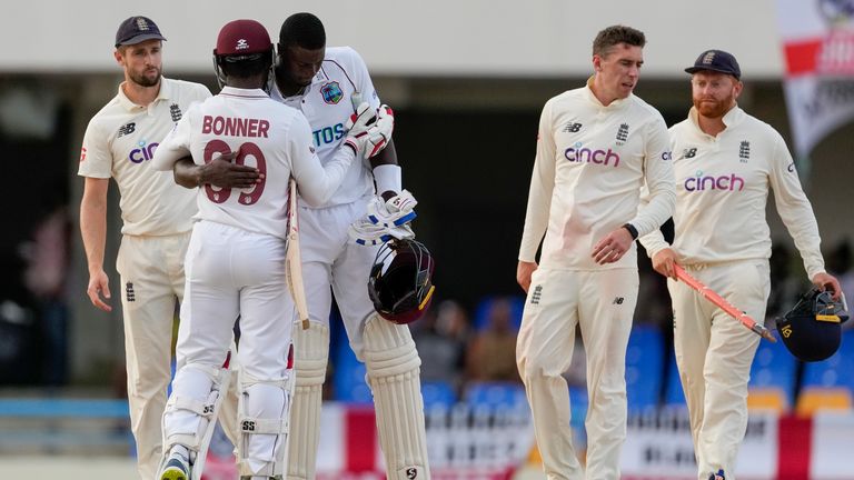 Jason Holder and Nkrumah Bonner hug after the match ended in a draw