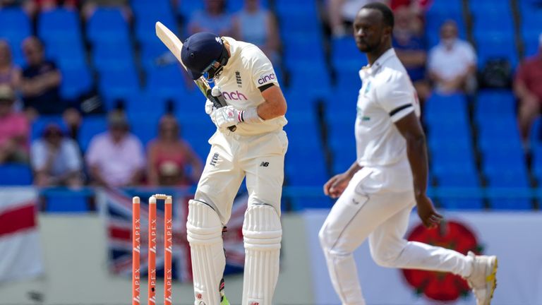 Joe Root is seen after being thrown by Kemar Roach from the West Indies