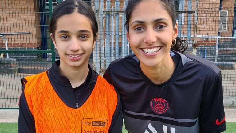 Young footballer from Essex standing with freestyle footballer Calgate Atwal (right)