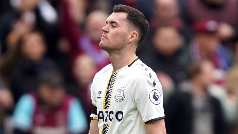 Michael Keane is taken off the field after receiving a red card for challenging Michael Antonio