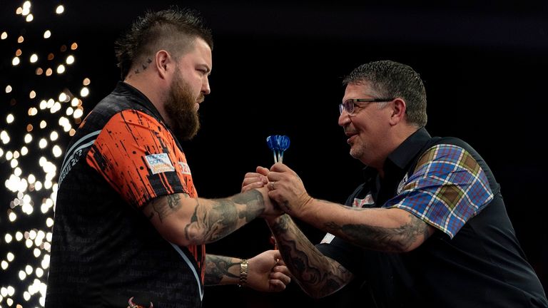 Michael Smith shakes hands with Gary Anderson after winning his quarterfinal match during the 2023 Cazoo Premier League quarterfinal match in Brighton (Pic: Steven Paston/PDC)