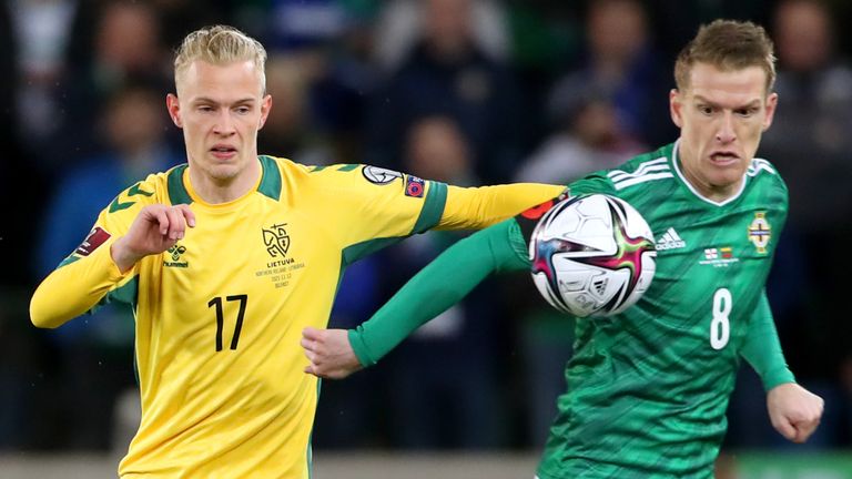 Northern Ireland Stephen Davis and Lithuania Justas Lasikas compete for the ball