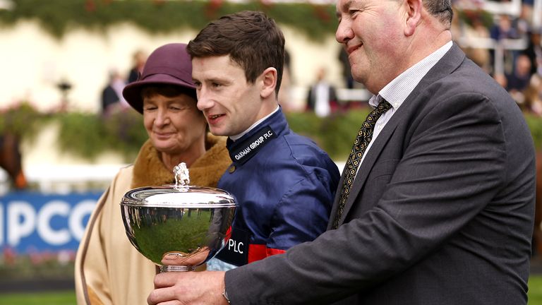 Oisin Murphy holds the trophy after being champion in Jockey Racing for 2023