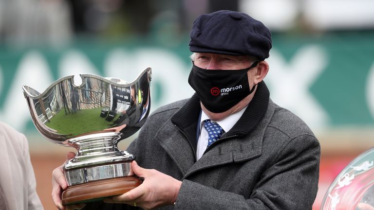 Sir Alex Ferguson, owner of Clan Des Obeaux, receives the Betway Bowl at Aintree