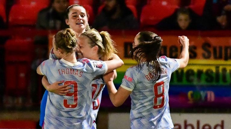 Ella Tone is attacked by her teammates after opening the scoring for Manchester United